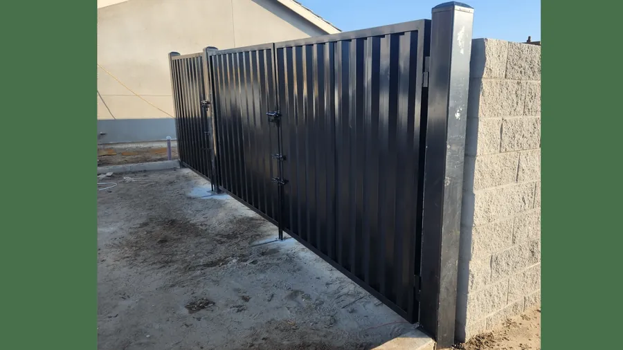 Black steel dumpster enclosure gates fabricated and installed by Palmer Fence near Sacramento