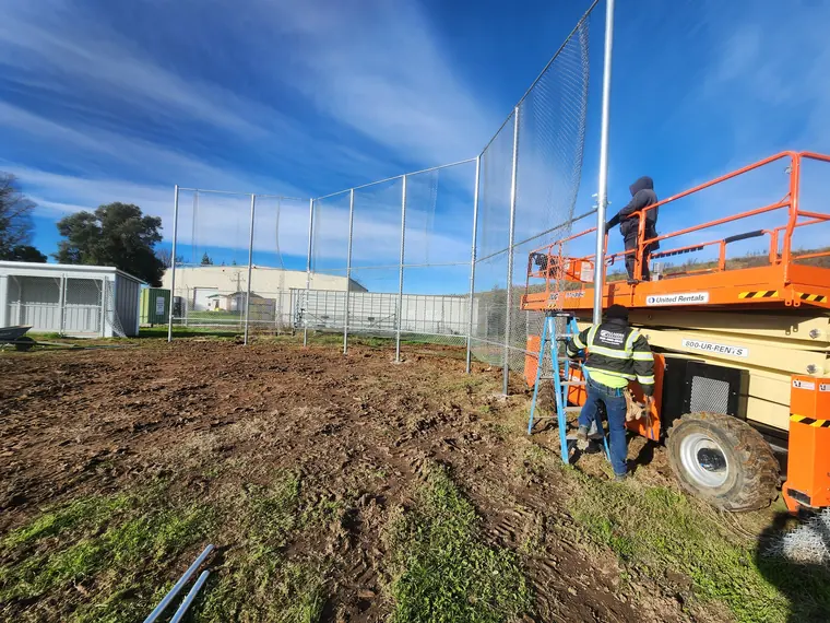Palmer Fence crew setting a tall chain link fence in the Sacramento area