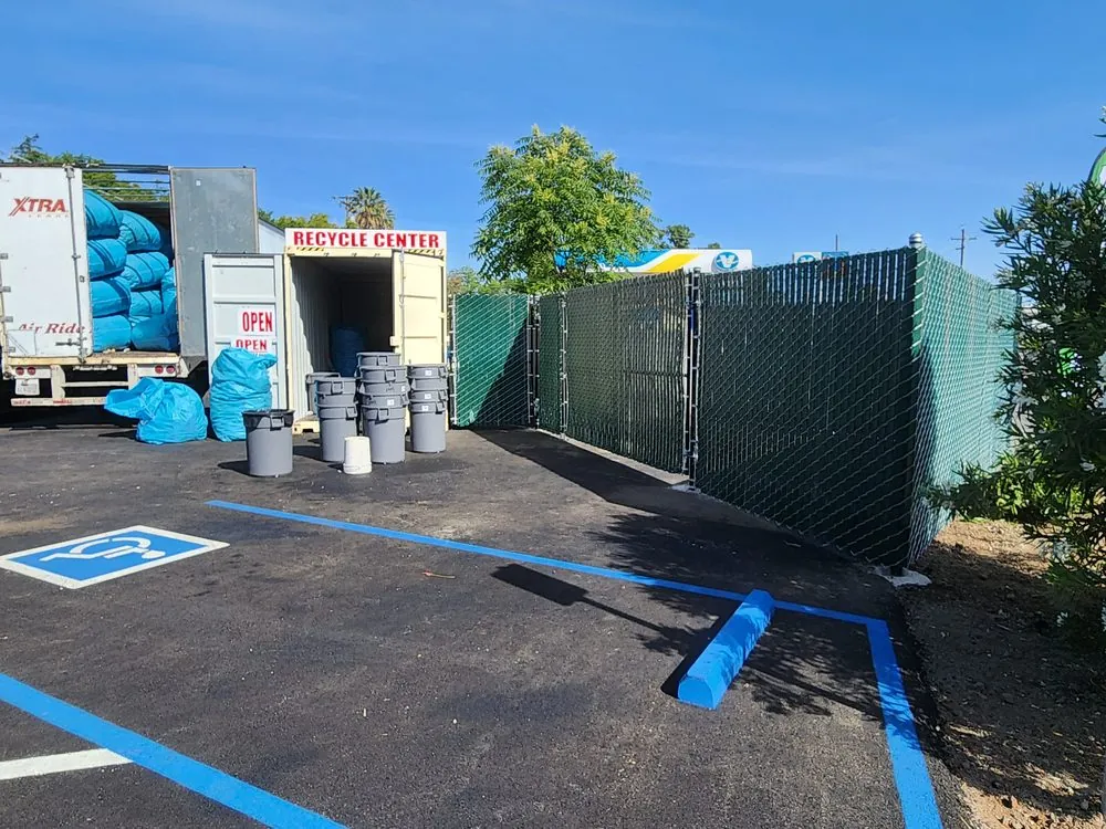 Commercial chain link enclosure with green privacy slats built by Palmer Fence near Sacramento
