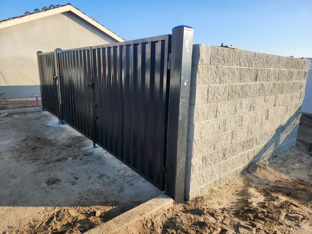 Commercial dumpster enclosure gate on a block wall built by Palmer Fence near Sacramento