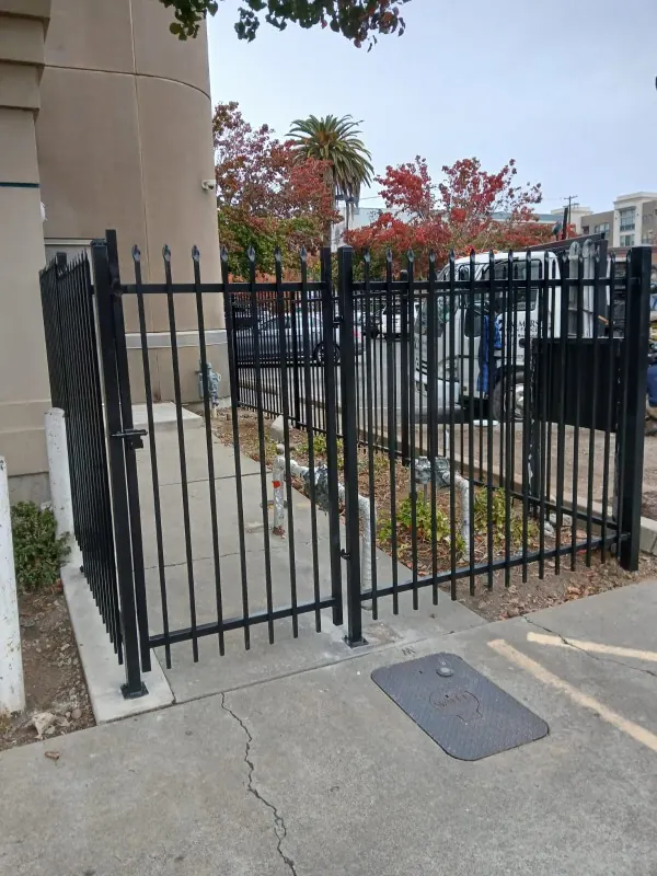 Black spear-top swing gates with a man gate at a Sacramento storefront, built by Palmer Fence