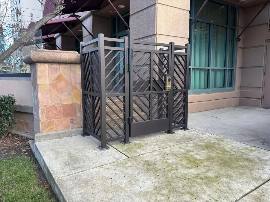 Custom iron gate and fence panel at the Sacramento hotel in bronze powder coat