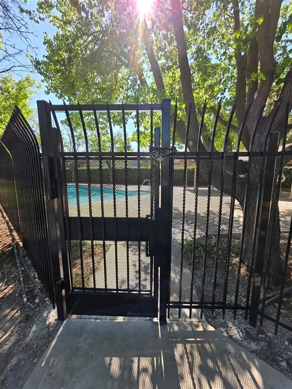 Black ornamental iron fence and gate by a community pool in Elk Grove, by Palmer Fence