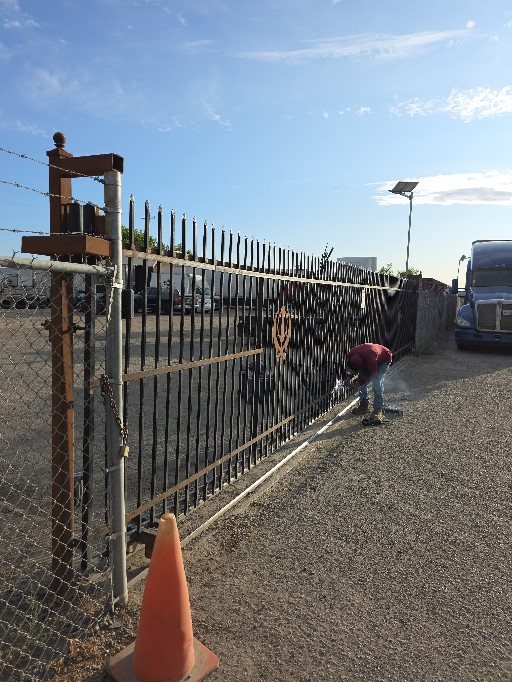 On-site welding repair of an iron fence at a West Sacramento trucking yard