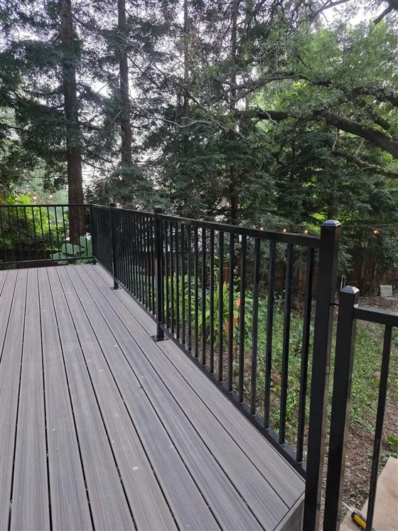 Steel deck guardrail with wire-mesh infill and a rolling gate, built by Palmer Fence in Sacramento