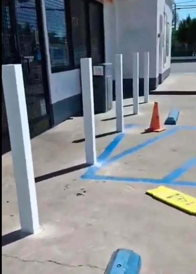 White square steel bollards protecting the storefront of a West Sacramento gas station, installed by Palmer Fence