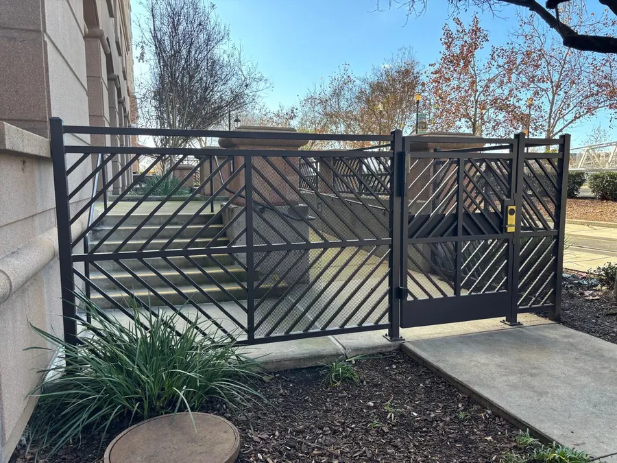 Custom ornamental iron fence and gate matched to the hotel's existing ironwork, Sacramento