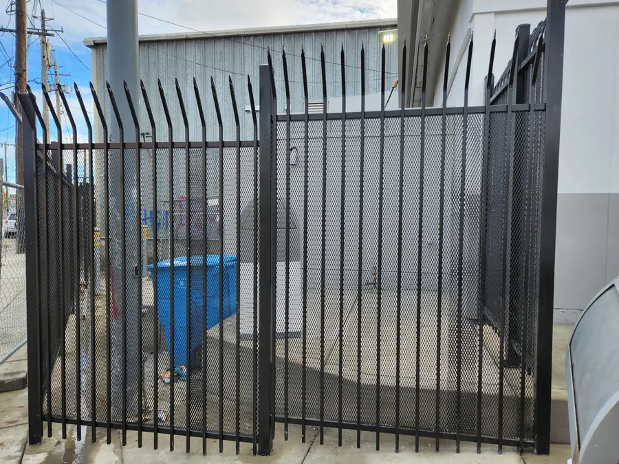 Expanded metal sheet behind ornamental iron pickets on an 8-foot security fence in San Francisco by Palmer Fence