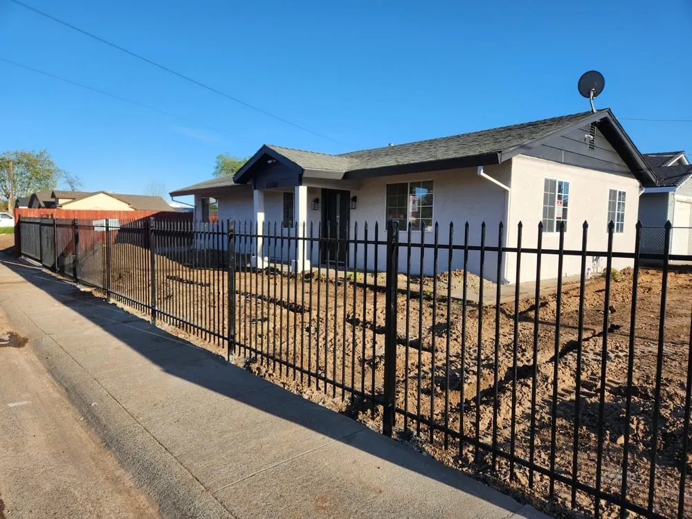 Black ornamental iron fence along the sidewalk at a Sacramento property, built by Palmer Fence