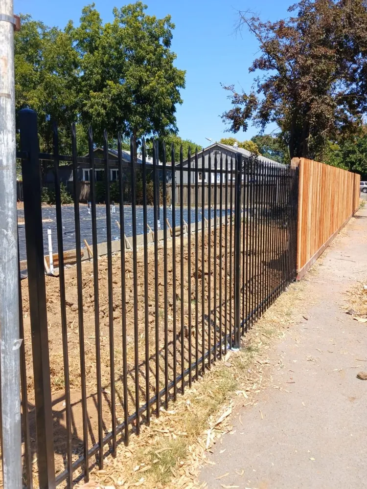 Black spear-top ornamental iron fence along a jobsite in the Sacramento area, built by Palmer Fence