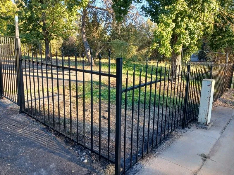 Black ornamental iron perimeter fence at a Sacramento-area lot, installed by Palmer Fence