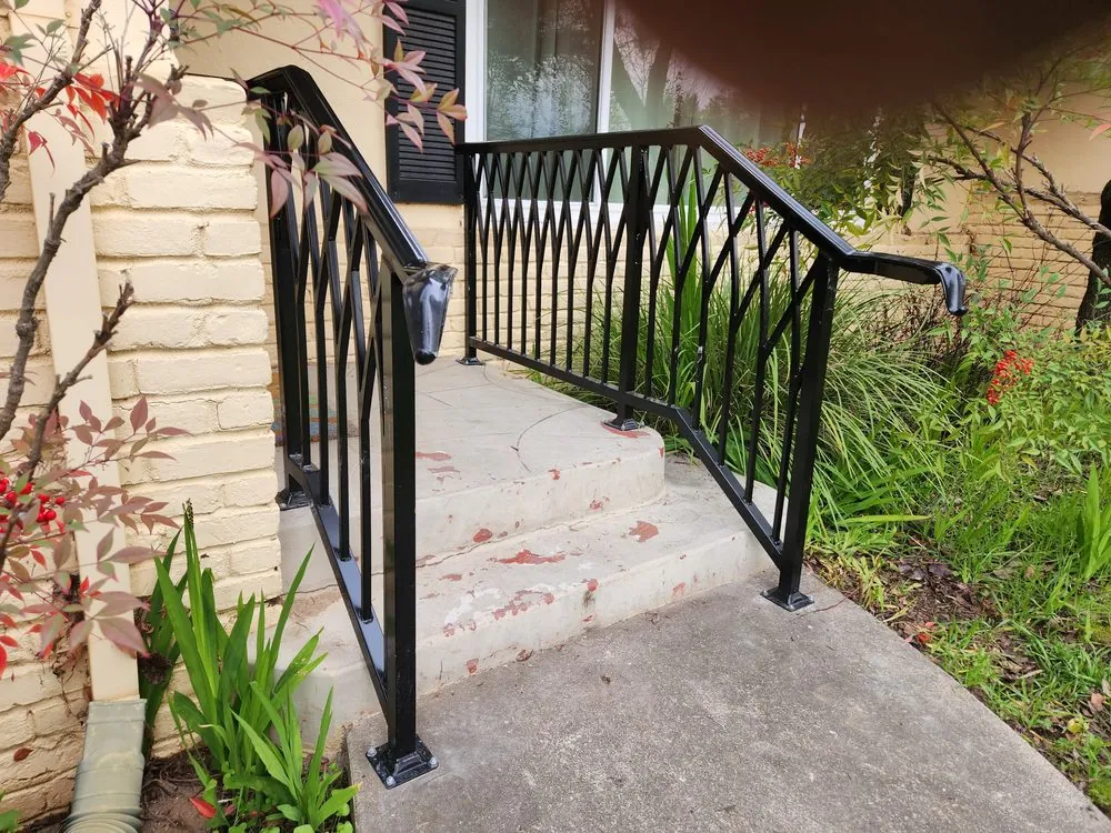 Black ornamental iron handrail on entry steps, installed by Palmer Fence in the Sacramento area