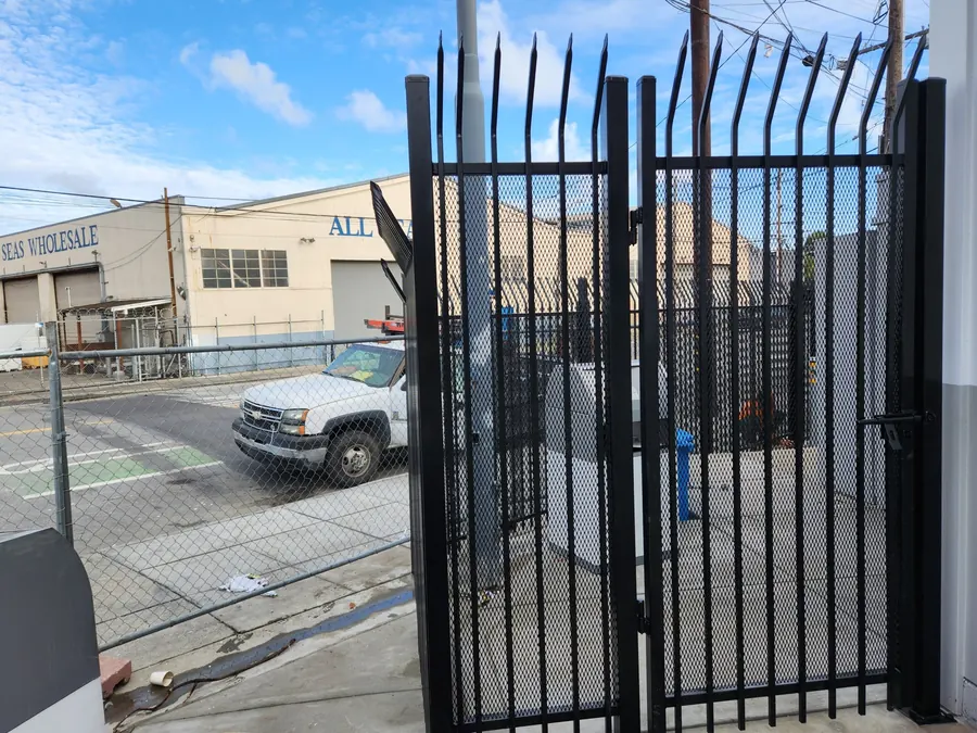 12-foot ornamental iron sliding gate with curved spear top and expanded metal infill, San Francisco