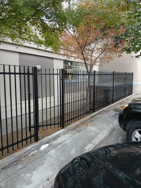 Prefabricated spear-top steel panel fence and gate at a commercial building in Sacramento, built by Palmer Fence