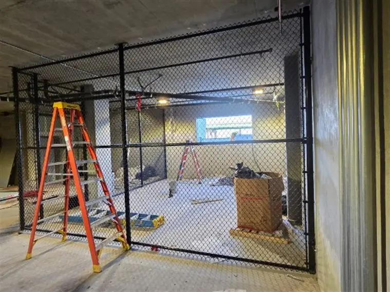 Black chain-link interior security cage built by Palmer Fence in West Sacramento