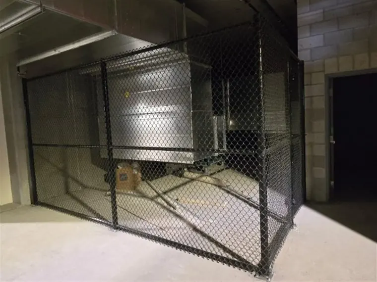 Interior black chain-link storage cage built by Palmer Fence in West Sacramento