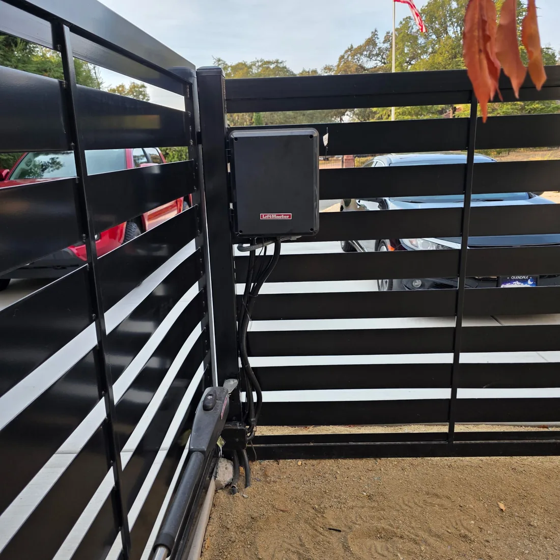 LiftMaster control box and swing gate operator on a black horizontal slat gate, installed by Palmer Fence
