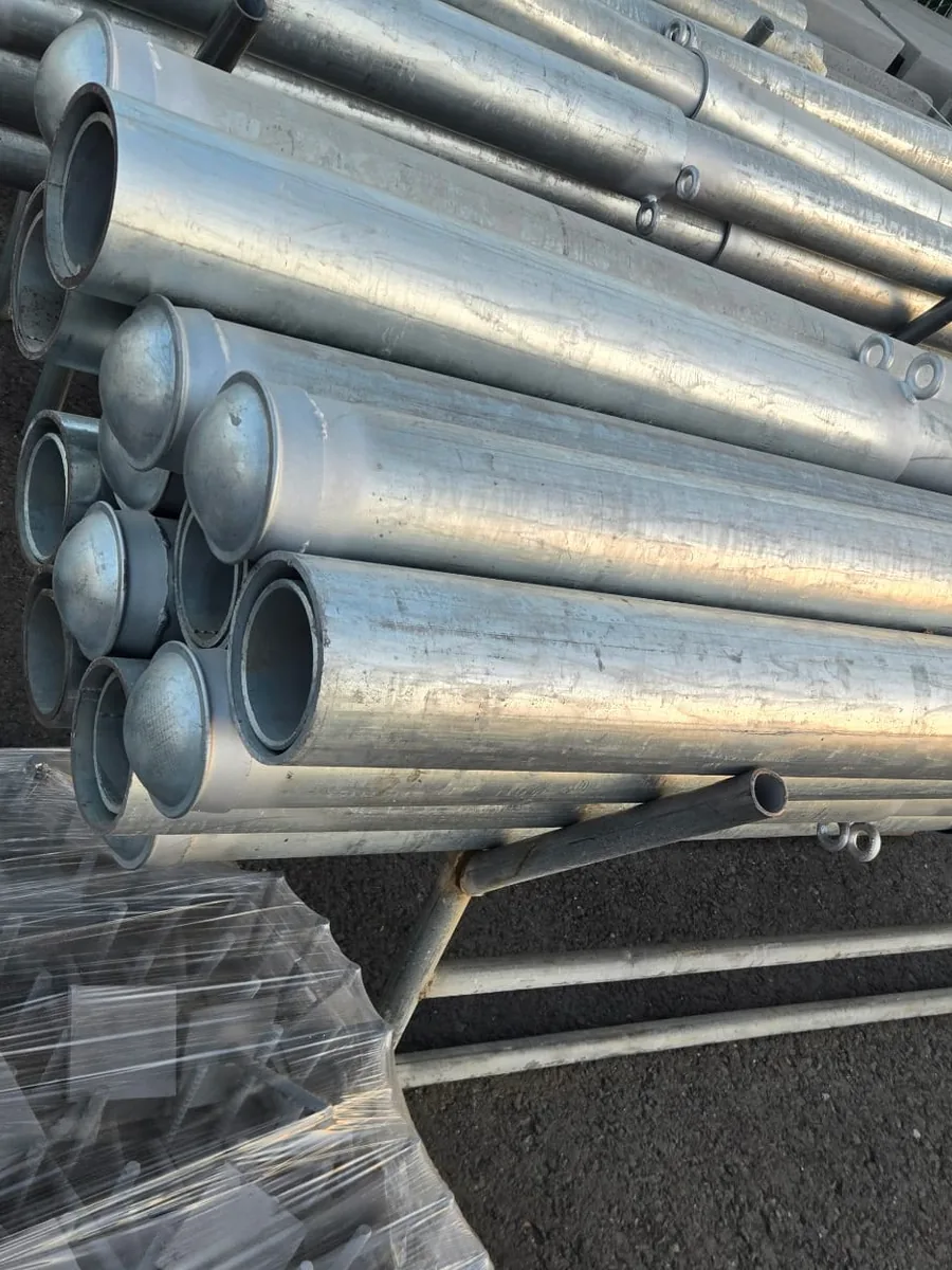 Removable steel bollards before install: galvanized posts with domed caps and welded lifting rings, Palmer Fence